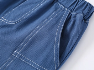 Detail of blue boys' casual shorts featuring elastic waistband and reinforced stitching