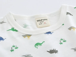 Close-up of baby cotton t-shirt collar featuring colorful cartoon dinosaur prints