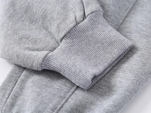 Detailed macro view of grey cotton-blend ribbed cuffs on children's joggers