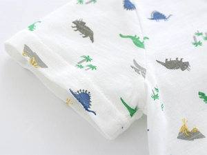 Close-up of breathable bamboo cotton fabric with colorful dinosaur prints on kids' T-shirt