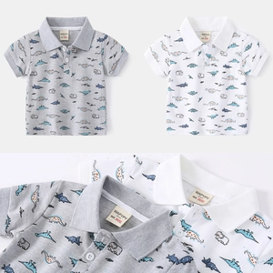 Boys short sleeve polo shirt with dinosaur print in grey and white cotton pique fabric