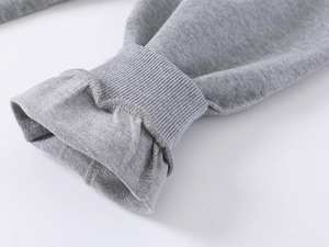 Detailed macro view of the grey ribbed cuffs and knitted cotton texture on kids joggers