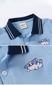 Detail of baby polo shirt collar with blue stripes and cat embroidery pattern