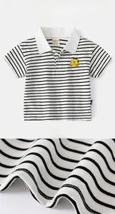 Detail of kids striped polo shirt with yellow cartoon embroidery and knit texture