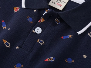 Detail of navy boy's polo with breathable pique fabric and colorful space icons