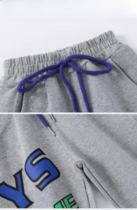 Détails du jogging gris pour enfant avec taille élastique et cordon de serrage violet