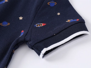 Close-up of navy piqué cotton polo shirt sleeve with white stripes and space pattern