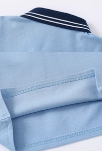 Detail of light blue pique cotton polo shirt showing neat double-needle hem stitching