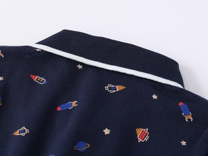 Close-up of navy piqué polo shirt featuring space theme rocket and star embroidery