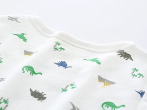 Close-up of boys white cotton t-shirt collar with colorful dinosaur pattern