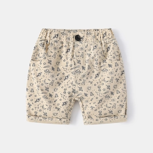 Kids beige summer shorts with black space doodles featuring rockets and astronauts