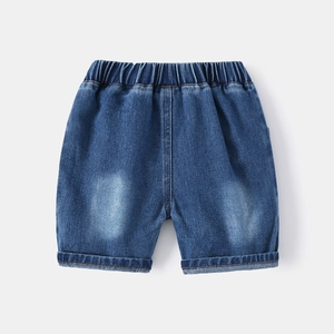 Detail view of elastic waistband and rolled cuffs on kids washed blue denim shorts