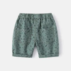 Kids green space print shorts with elastic waist and alien UFO patterns on flat lay