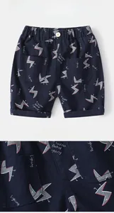 Detail of boys navy cotton shorts with cartoon prints and elastic waist pockets