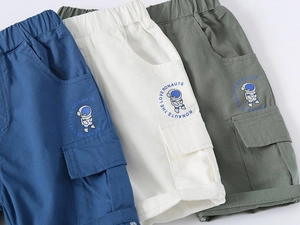 Close-up of cotton boys' cargo shorts in three colors with astronaut print details