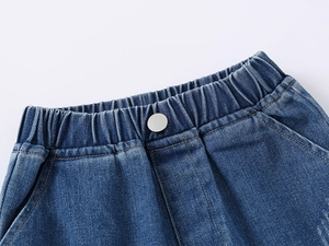 Detail of boys' denim shorts featuring elastic waistband and silver metal button closure