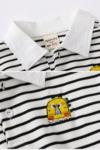 Close-up of boys polo shirt featuring striped fabric and dinosaur embroidery detail