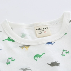 Toddler boys white short sleeve t-shirt featuring colorful cartoon dinosaur prints and round neck