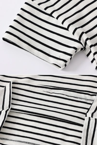 Detail of sleeve stitching and striped cotton knit fabric texture on a kids polo shirt