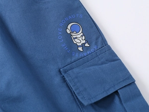 Detail of blue cargo shorts for boys featuring astronaut print and flap pocket