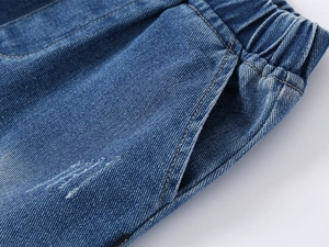 Detail of boys' denim shorts featuring elastic waistband and side pocket stitching