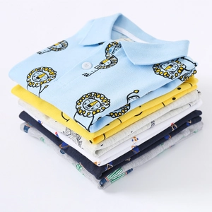 Folded kids cotton pique polo shirts in various colors with cute cartoon animal prints