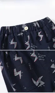 Detail of navy blue boys' cotton shorts featuring lightning prints and elastic waistband