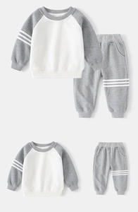 Detailed flat lay of children's grey and white ribbed track suit with side stripes