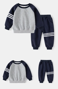Flat lay of boys navy and grey athletic sweatshirt and pants set with side stripes