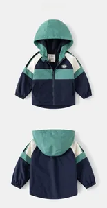 Close-up of color-block hooded jacket showing front and back with Dream patch detail