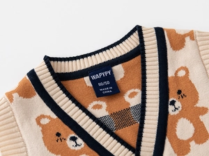 Detail of V-neckline and cute bear patterns on a soft knit vest for boys