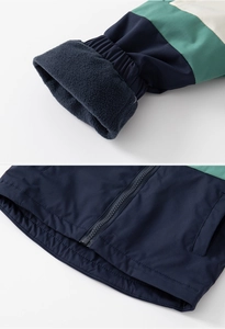 Detail of color-block jacket showing elastic cuffs, fleece lining and front zipper