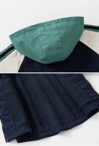 Detail view of boys hooded jacket featuring warm navy fleece lining and windproof color block fabric