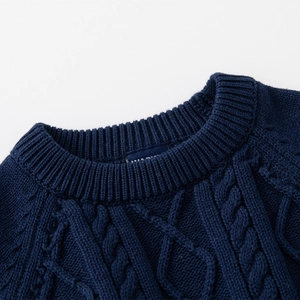 Close-up of navy blue cable knit texture and ribbed crew neck on kids' sweater