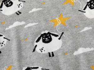 Detail of grey knitted sweater showing cute sheep, yellow stars and white clouds patterns
