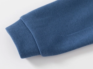 Detail of ribbed cuffs on a dark blue knitted polo shirt for children's casual wear