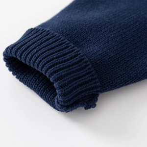 Close-up of navy blue ribbed knit cuffs on a warm children's thick winter sweater