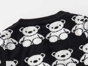 Detail of knit collar featuring white bear patterns on a black contrast cardigan