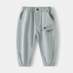 Close-up of child joggers featuring an elastic waistband with decorative button and side pocket