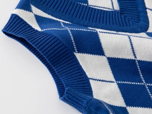Detailed view of the V-neckline and rib-knit cuffs on this blue argyle sweater vest