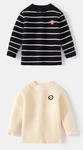 Detail showing ribbed knit texture of boys sweaters with small animal patches