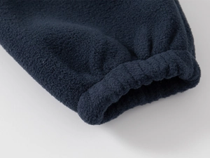 Detailed close-up of navy blue polar fleece sleeve cuff with elastic ribbed design