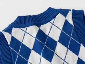 Detail of blue and white argyle knit vest neck and shoulder stitching texture