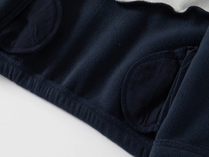 Detailed macro view of navy blue fleece lining and reinforced stitching on kid's jacket