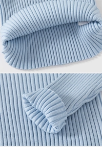 Detail of light blue ribbed knit texture and elastic cuffs on a thick children's sweater