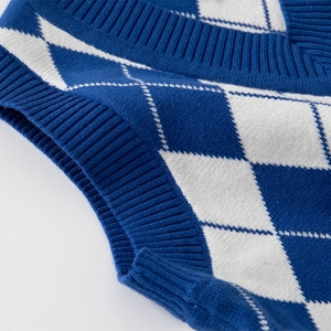 Boy's blue and white argyle knit sweater vest with V-neck and ribbed trim details