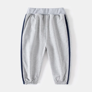 Close-up of elastic ribbed cuffs and side stripe detail on light gray kids sweatpants