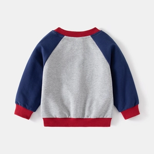 Detail of color-block kids sweatshirt with navy raglan sleeves and red ribbed cuffs