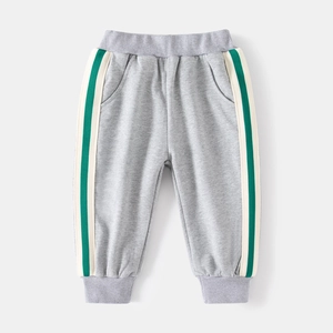 Detail of grey kids joggers featuring elastic waist and side stripes with ribbed cuffs