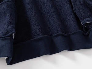 Detail of dark blue kids' jacket with warm fleece lining and elastic ribbed hem